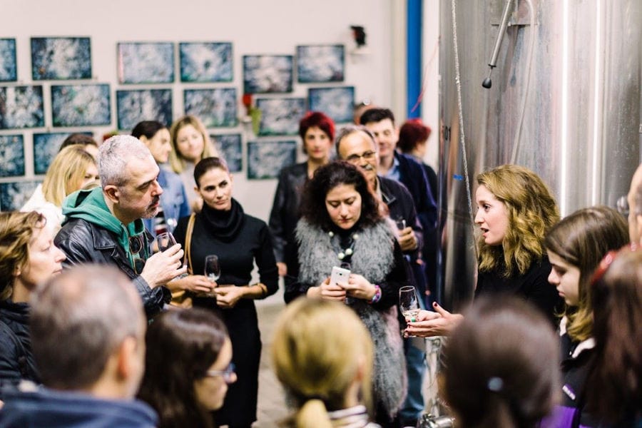 Tourists enjoy a wine tasting at Strofilia winery and listening to a guide